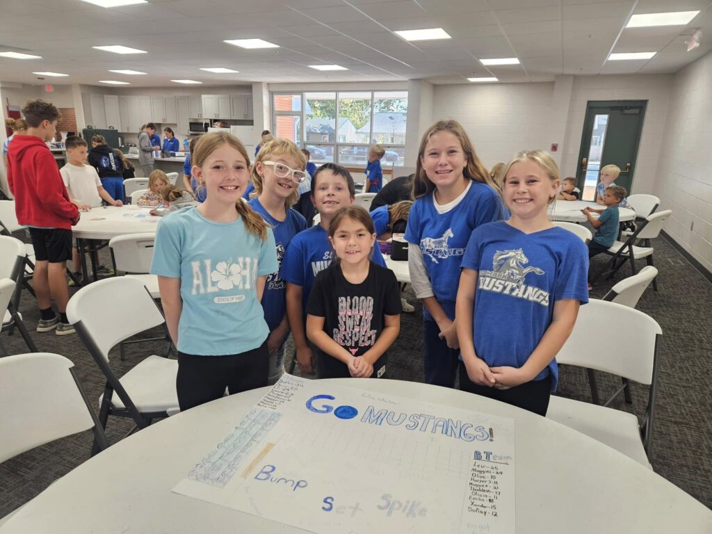 Kids making volleyball posters